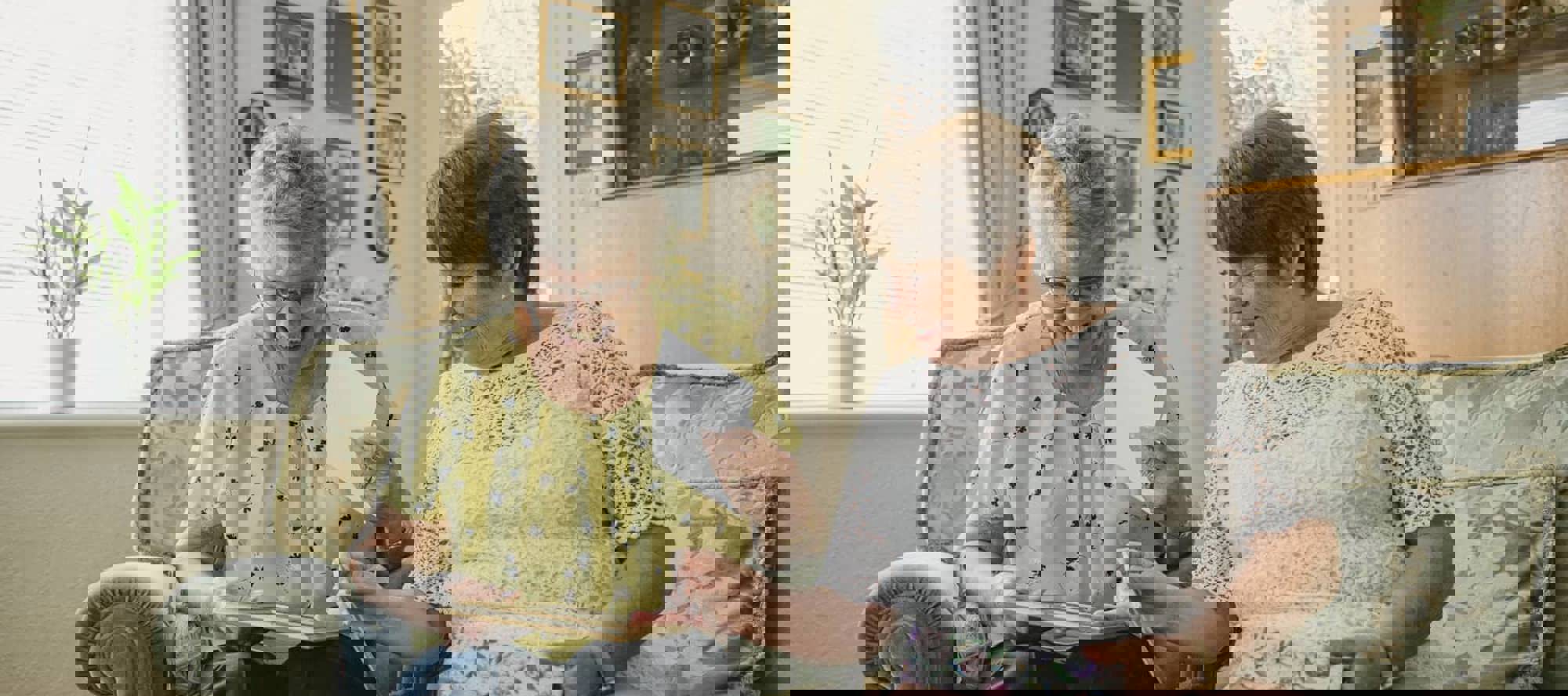 two adults sat next to each other on a sofa